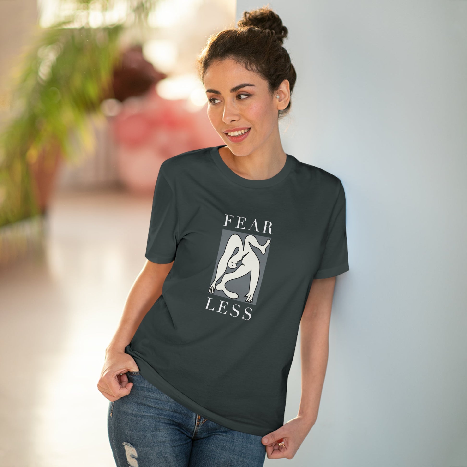 Make a statement with the feminist 'Fear Less' organic cotton t-shirt, designed for all genders.