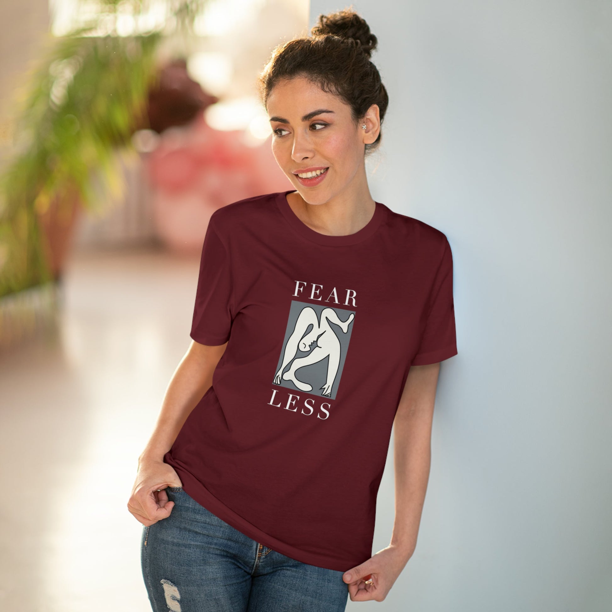 The feminist 'Fear Less' organic cotton t-shirt blends activism and style in a gender-neutral design.