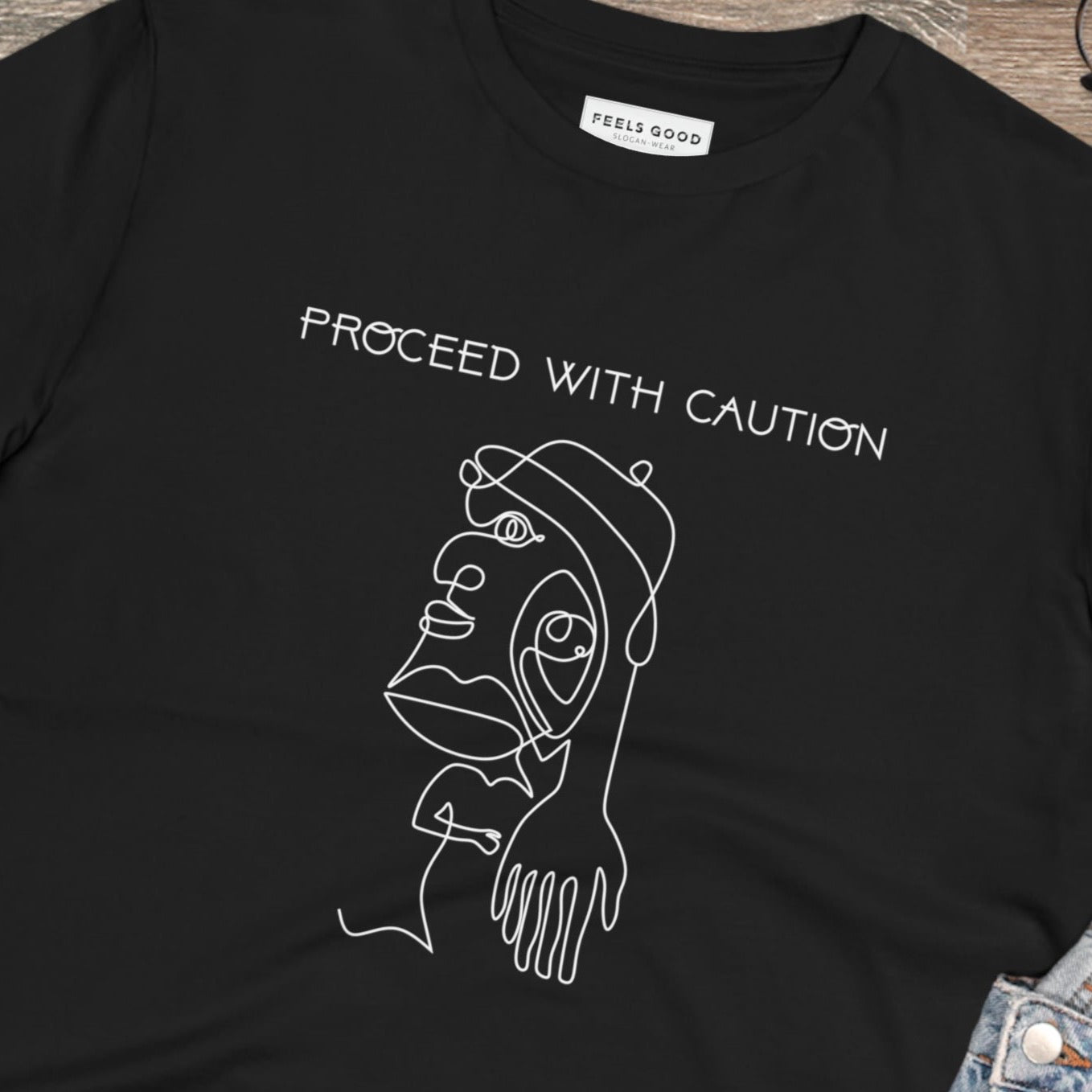 Stay bold with the feminist 'Proceed With Caution' organic cotton t-shirt – wear your power proudly!