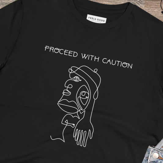 Stay bold with the feminist 'Proceed With Caution' organic cotton t-shirt – wear your power proudly!