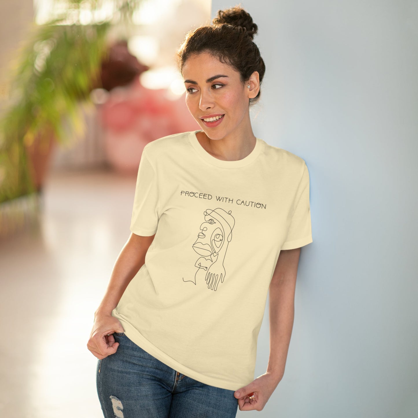 The feminist 'Proceed With Caution' organic cotton t-shirt is a must-have for gender-neutral fashion.