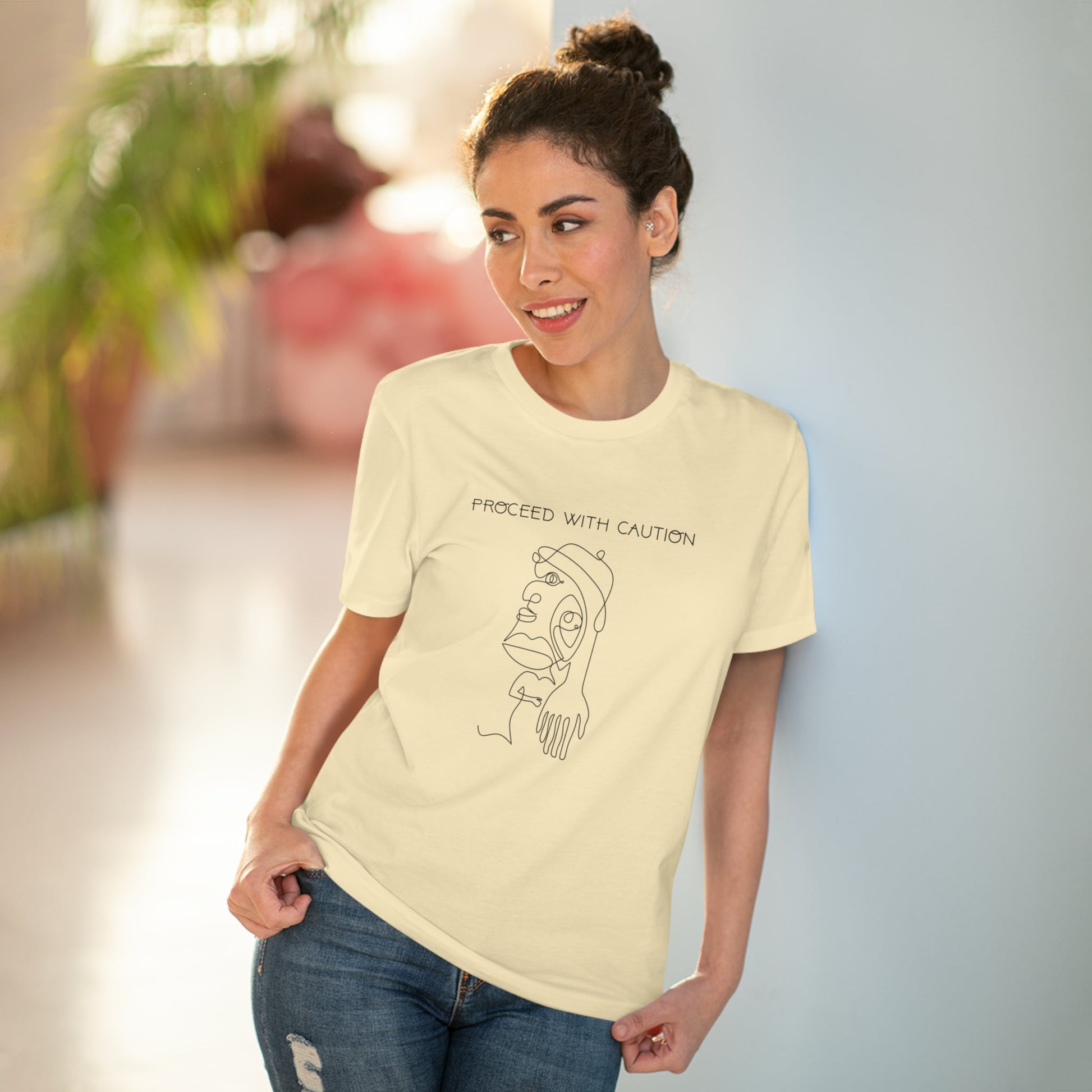 The feminist 'Proceed With Caution' organic cotton t-shirt is a must-have for gender-neutral fashion.